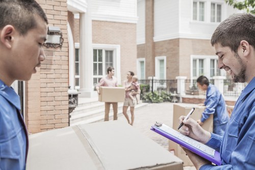 Professional piano removals service preparing an upright piano for safe transport in Brent