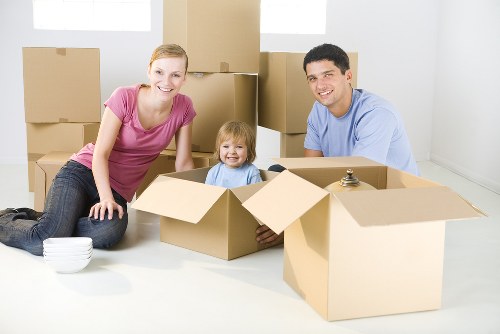 Movers handling a flat removal in Brent with boxes and furniture