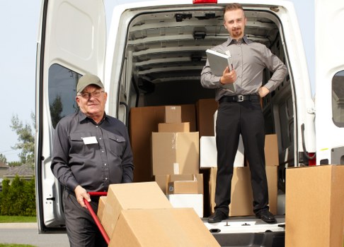 Man with van loading furniture for a local move in Brent