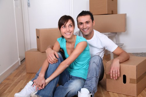 Local moving truck loading boxes and furniture in Brent